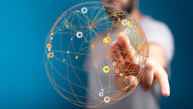 Abstract image representing global communication, networks, connections, and technology. A hand reaching out to touch a digital spher