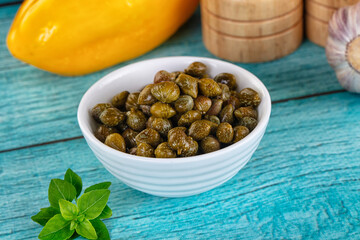 Pickled canned capers in the bowl