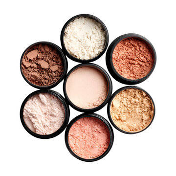 Collection of assorted makeup powders in circular containers arranged on a white background