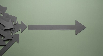 A group of grey paper arrows with one pointing right on a solid green background.