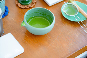 Matcha tea ceremony set two cups on green slate plate, traditional Japanese tea top view with flat lay concept.