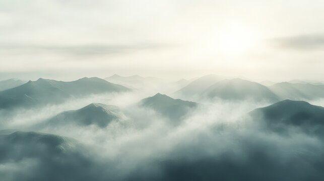 Expansive view of misty mountains during early morning light capturing the beauty and tranquility of nature
