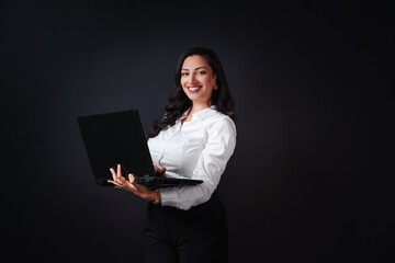 Luxurious smiling woman using laptop computer for online learning education or business job, isolated on black background
