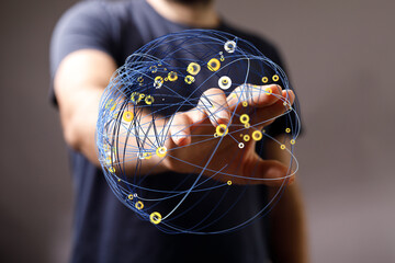 Abstract conceptual image of a hand holding a glowing sphere of interconnected lines, representing...