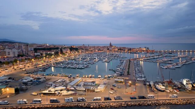 Aerial view of evening seaside fortress, scenic drone footage captures italian coast fortress during sunset evening. Algero