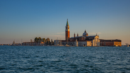 The photograph depicts St Mark's Square (Piazza San Marco) in Venice. Dominating the square is the bell tower (Campanile di San Marco)