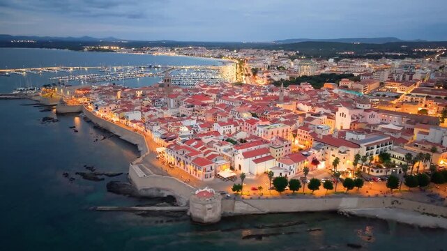 Aerial view of evening seaside fortress, scenic drone footage captures italian coast fortress during sunset evening. Algero