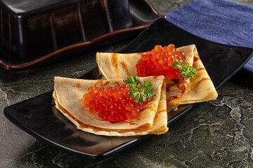 Russain traditional pancakes with red caviar