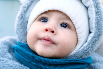 Happy little baby boy making outdoors in winter. Cute toddler in winter cloth. Child having fun on...