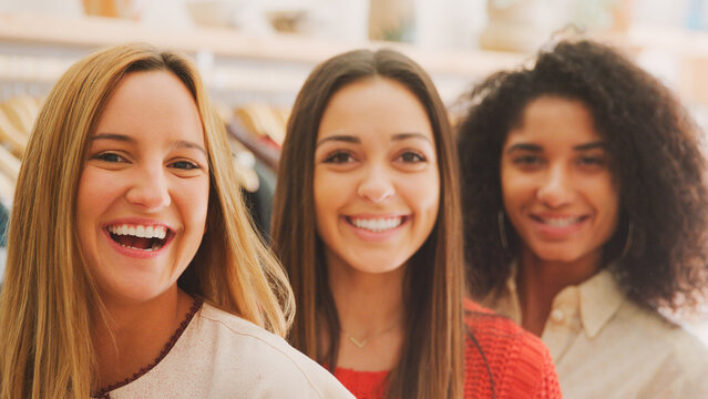 Portrait Of Three Female Sales Assistants Working In Clothing And Gift Store