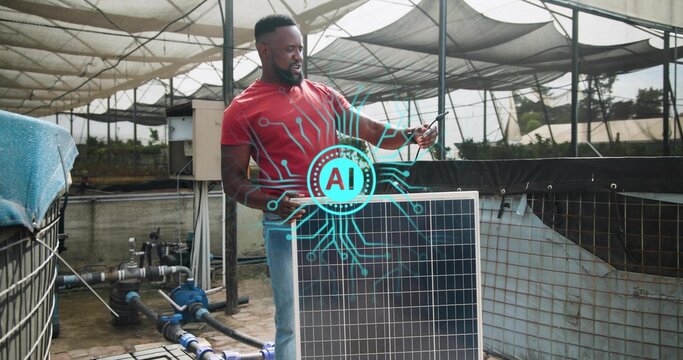 Holding solar panel, man wearing red shirt, jeans checking phone in shadehouse, with pumps