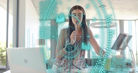 Speaking woman wearing sleeveless top and headphones, holding mic in bright office HUD treadmill