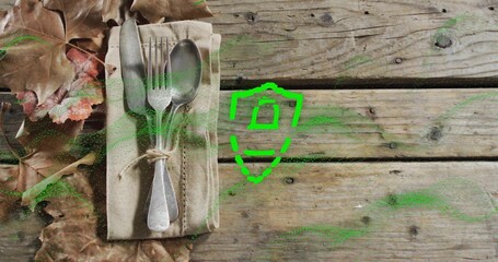 Placing beige napkin with three utensils and twine on wooden tabletop, green shield, copy space © vectorfusionart