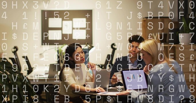 Collaborating three colleagues in office attire at table showing laptop chart, with data overlay