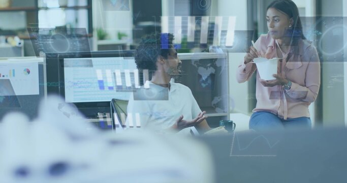Discussing coworkers at office in white shirt pink blouse using chopsticks, glass-reflected data