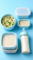 Colorful containers filled with rice, peas, and baby food arranged on a blue background for meal prep