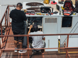 Industrial air conditioning repair technicians at work