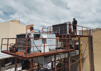 Industrial air conditioning repair technicians at work