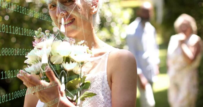 Senior woman adjusting bouquet while camera pulling back, revealing binary overlay for wedding