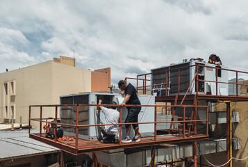 Industrial air conditioning repair technicians at work