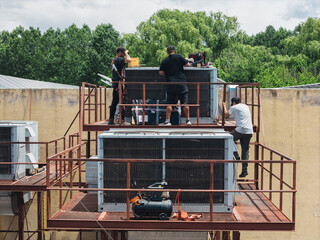 Industrial air conditioning repair technicians at work