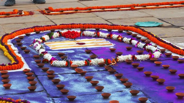Beautiful Shiva Lingam Rangoli decorated with flowers, colors, and sacred symbols during a Hindu ritual. It represents devotion, purity, and the spiritual art of India.