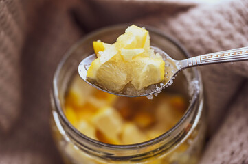 aromatic lemon jam with large lemon wedges on a spoon