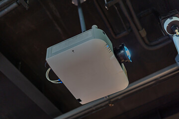 The projector is mounted on the ceiling of the room.