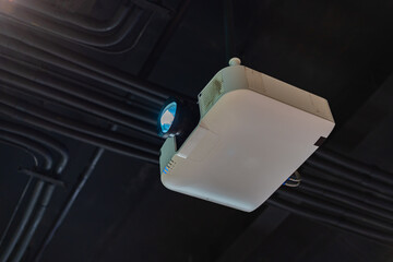 The projector is mounted on the ceiling of the room.