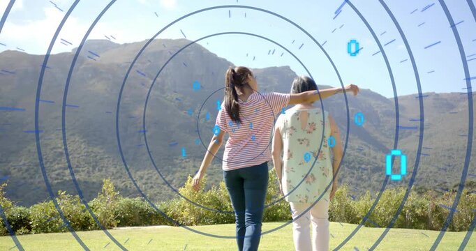 Teen reaching, draping arm over mature woman, walking to ridge, binary overlaying tech showing care