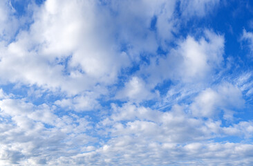 Blue sky with scattered white clouds on a sunny day