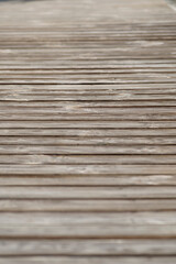 Weathered wooden boardwalk with shallow depth of field