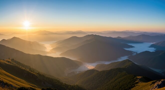 Scenic mountain landscape at sunrise. Golden light over foggy valleys and layered peaks. Nature and adventure travel background - Powered by Adobe