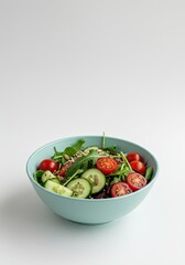 Vibrant, healthy vegetarian salad bowl featuring mixed fresh greens, colorful cherry tomatoes, cucumber slices, and nutritious seeds on a white background ,lunch ,homemade ,above