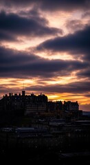 Naklejka premium Dramatic cityscape at sunset with cloudy sky
