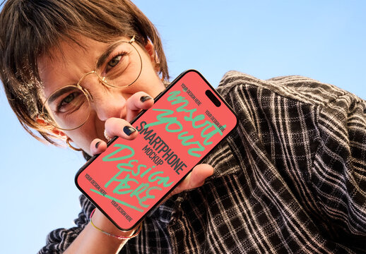 Mockup Template of screen smartphone Held by a Young Woman Against the Sky.
