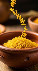 Golden Rice Grains Pouring into a Rustic Clay Bowl.