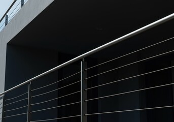 Architectural detail of a contemporary balcony railing system. Smooth metal posts and horizontal cables provide safety and minimalist aesthetics, geometric, abstract, design