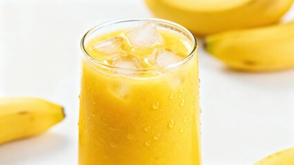 Refreshing chilled beverage made from tropical fruit sits next to whole ripe fruits