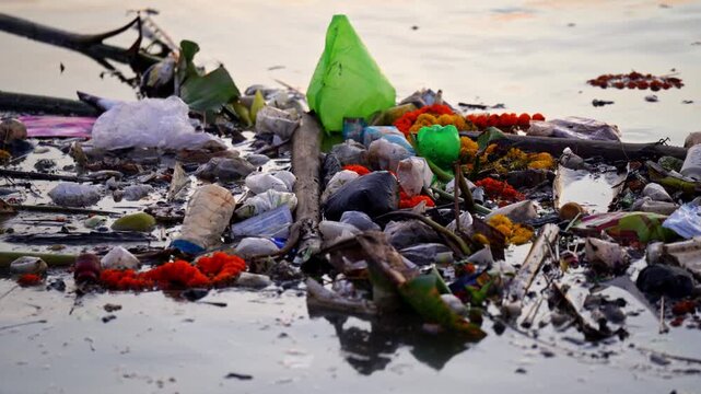 Plastic waste and garbage floating in the river water.