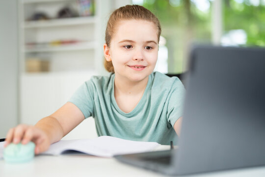 Back to school. Child with laptop at school classroom. Student sitting at desk during distance school class. Smart child study in virtual school.