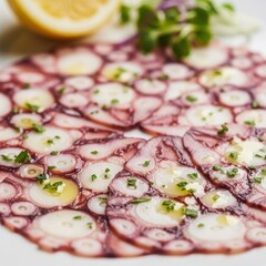 Thinly Sliced Octopus Carpaccio Appetizer with Lemon and Greens.
