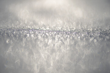 Frozen icy field in natural light. Minimal clean winter background. Frozen surface with snow and frost texture.