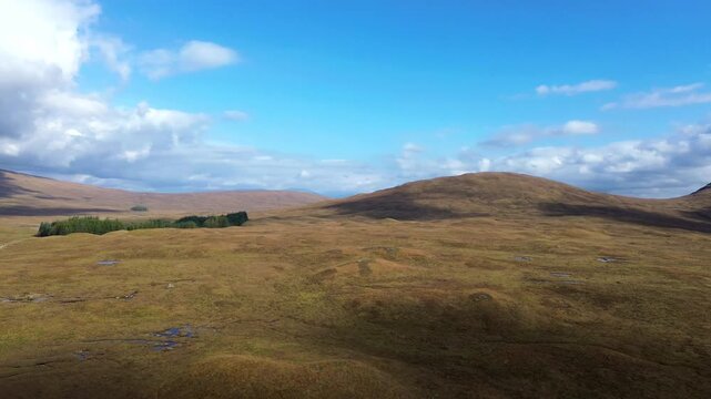 Drone aerial shot of a Fields, Grassland in Glencoe, filmed in the Lake, River under Sunny, Clear weather conditions. The Orbit, rotation captures the Lonely, Isolated beauty of Scotland&rsquo;s natural lan