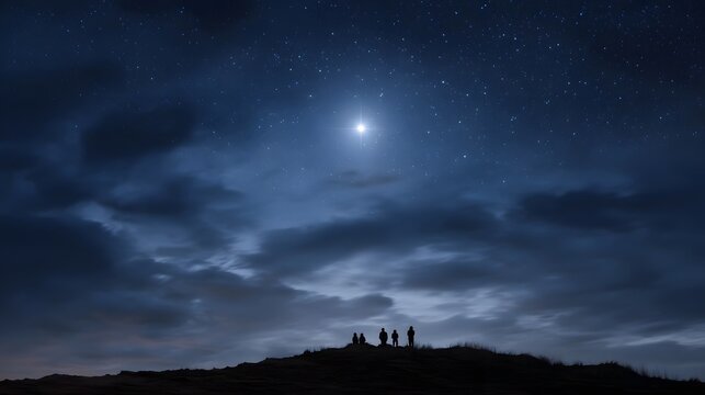 A bright star shines through stormy clouds over silhouetted figures on a hill at night