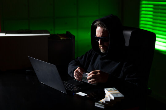 Crypto currency hacking. Hacking hunting for crypto currency. Cryptocurrency hack. Hacker in hoodie dark night theme. Digital data security concept. Hackers attack. Cybersecurity, Internet crime.