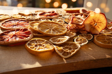 Dried citrus fruits and apple rings on rustic wood for the christmas.Preparations for christmas hot drinks.