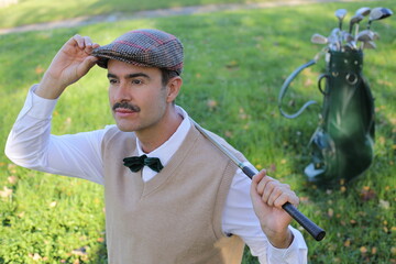 Golf player adjusting his hat during a sunny day 