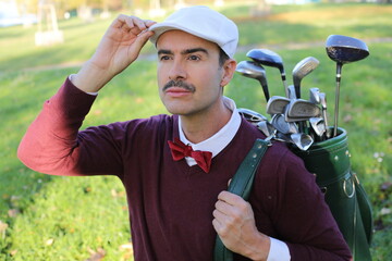 Golf player adjusting his hat during a sunny day 