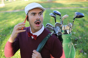 Shocked looking golfer during a phone call 